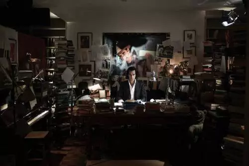20,000-days-on-earth-2014-002-nick-cage-behind-desk-looking-to-camera