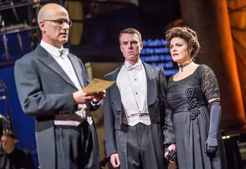 Conductor Nicholas Kok with Rupert Charlesworth as Nikolaus Sprink and Máire Flavin as Anna Sørensen in Opera North’s production of Silent Night by Kevin Puts [Photo credit: Tristram Kenton]