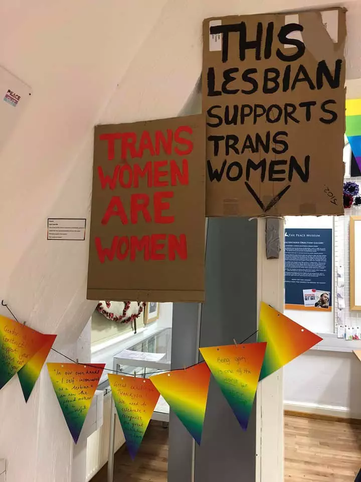 Handmade placards demonstrating support for trans women and bunting featuring visitor insights on LGBTQ+ culture